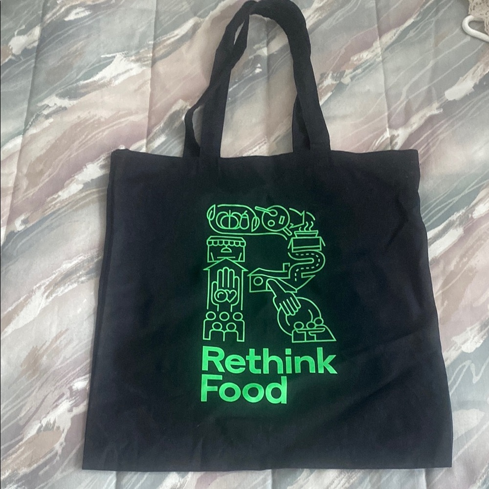 Reusable tote says Rethink Food black and green about 15 in long x 14.5 in wide.